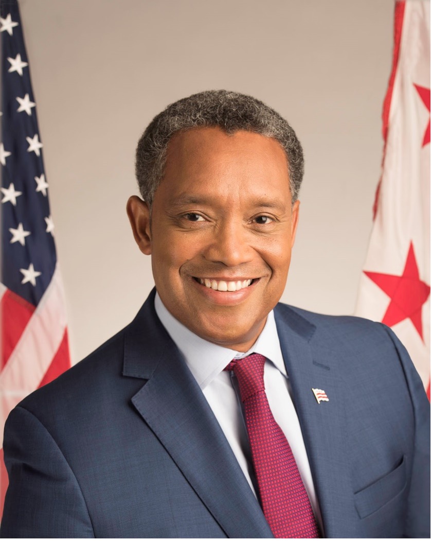 Man in suit in front of American flag